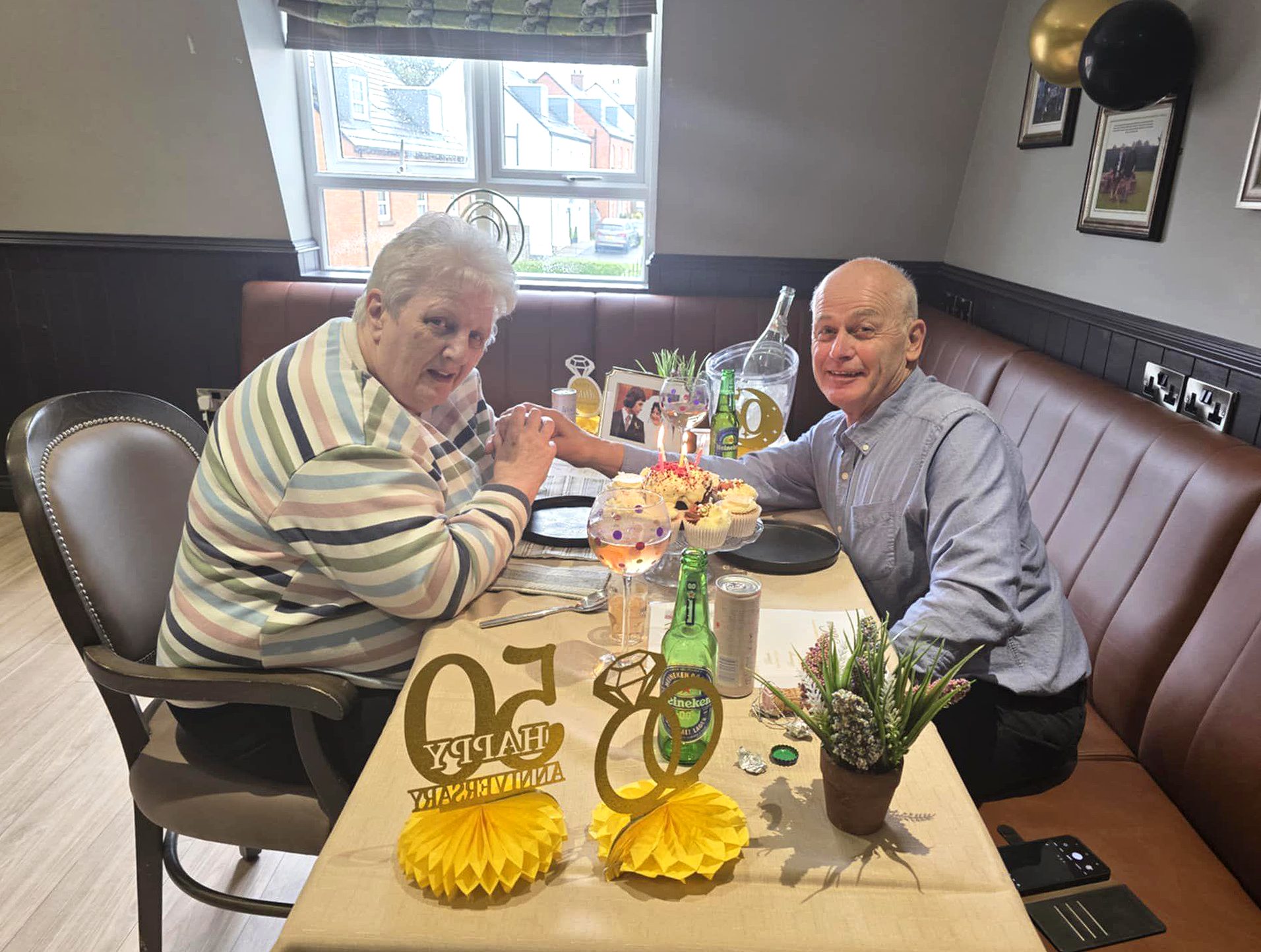 Resident Pat enjoying her wedding anniversary celebration in The Greyhound Bar at Milesian Manor with husband Everett.