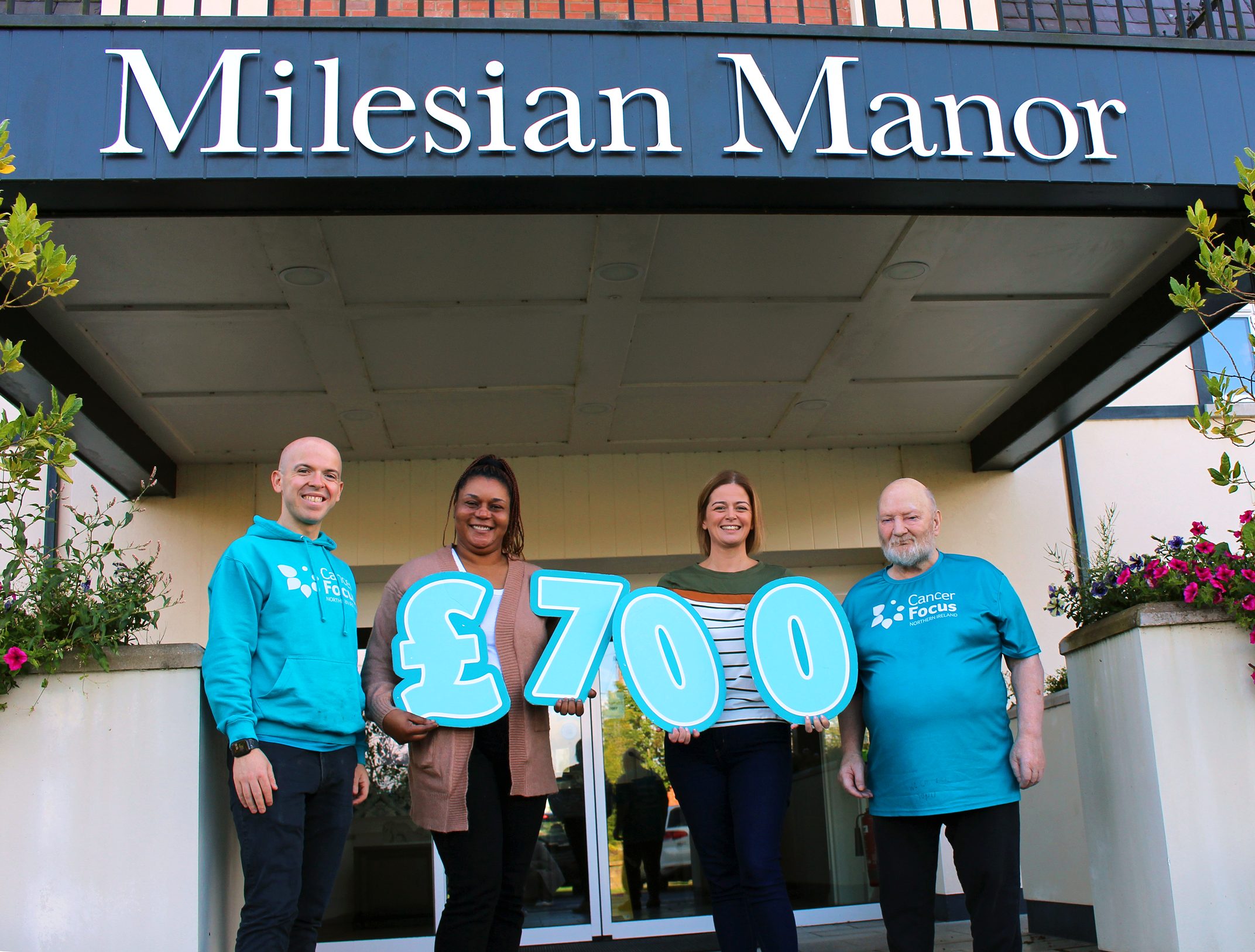 Eoin, Community Fundraising Officer at Cancer Focus NI with Home Managers Beauty & Julie and resident John.